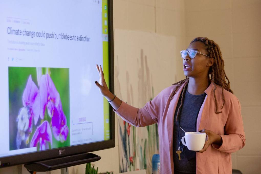 Woman pointing at a whiteboard