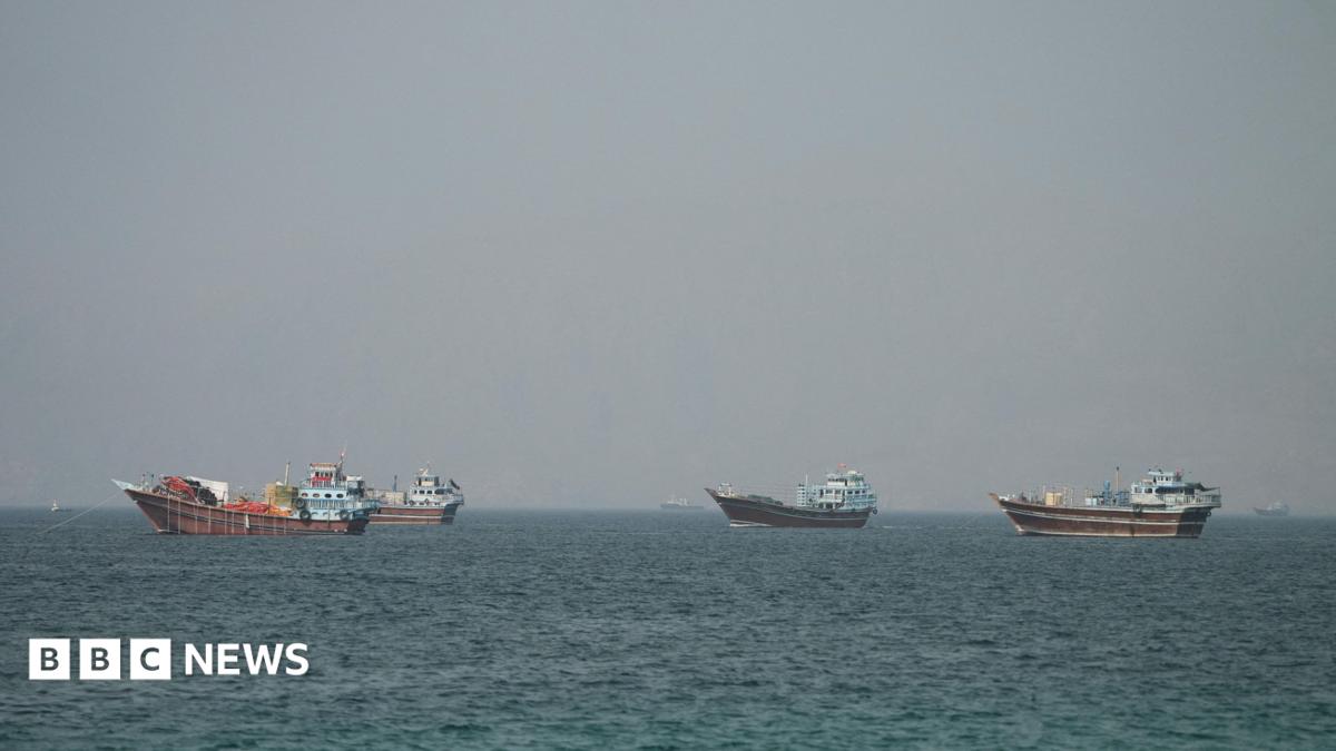Four large boats drifting on the Strait of Hormuz as seen from Oman.